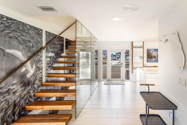 stairs featuring visible vents and recessed lighting