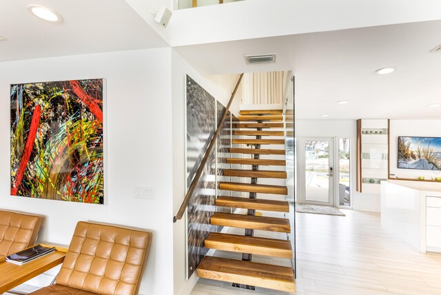 stairs with visible vents, french doors, wood finished floors, and recessed lighting