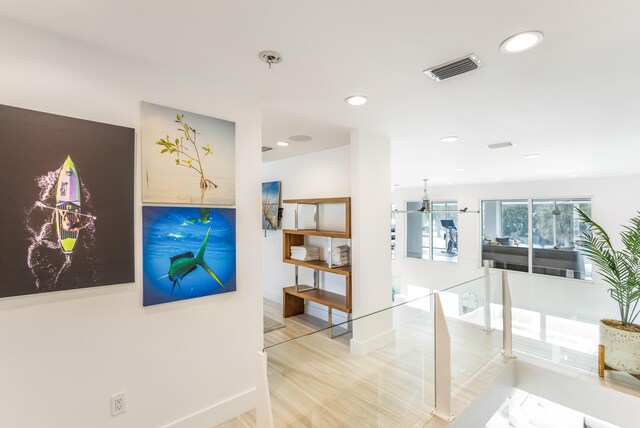 hallway featuring recessed lighting, visible vents, and baseboards