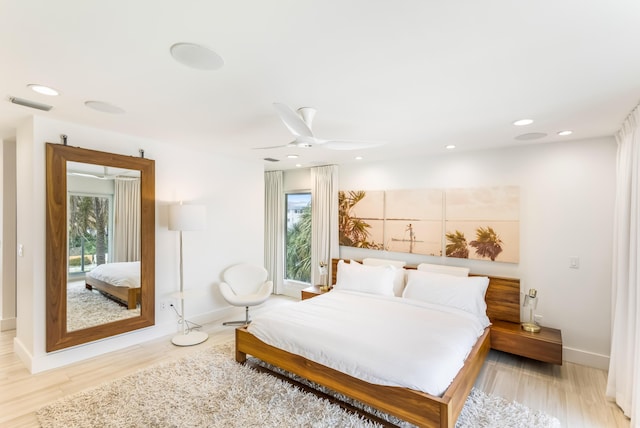 bedroom with light wood finished floors, visible vents, and recessed lighting