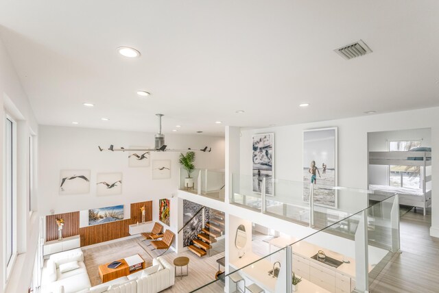 living room featuring stairway, visible vents, and recessed lighting