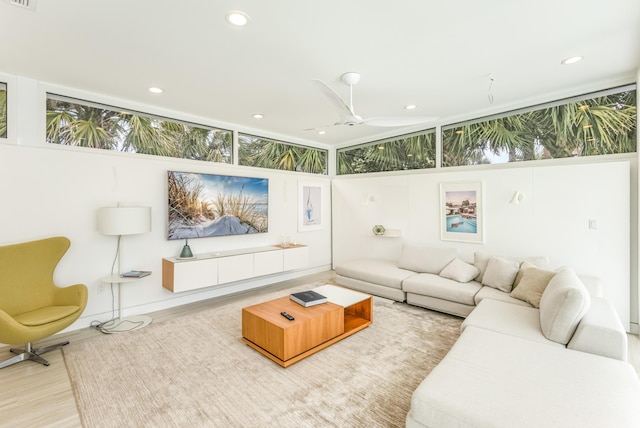 living area featuring a ceiling fan, wood finished floors, visible vents, and recessed lighting