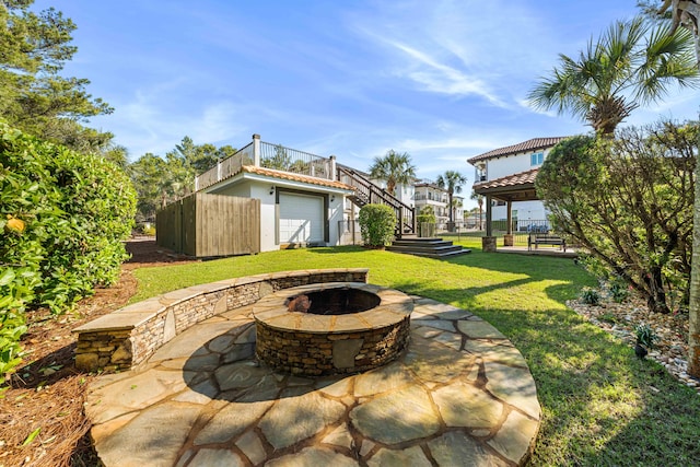 view of patio / terrace with a garage and a fire pit