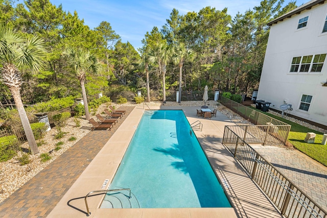 view of pool with a patio area and area for grilling