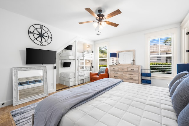 tiled bedroom featuring ceiling fan