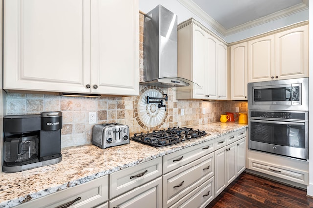 kitchen featuring dark hardwood / wood-style flooring, appliances with stainless steel finishes, wall chimney range hood, and tasteful backsplash