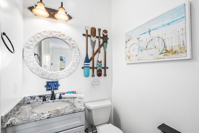 bathroom featuring toilet and vanity