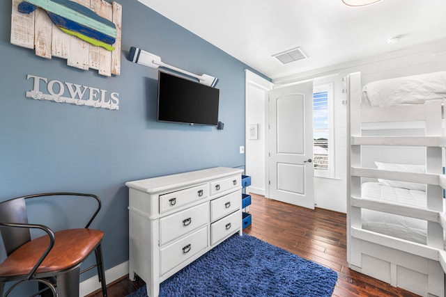 bedroom with dark hardwood / wood-style flooring