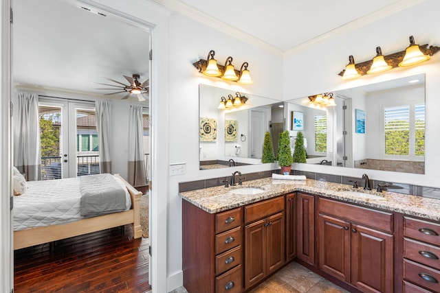 bathroom with ceiling fan, ornamental molding, wood-type flooring, french doors, and dual bowl vanity