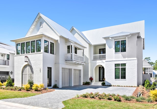 view of front of home featuring a garage and a balcony