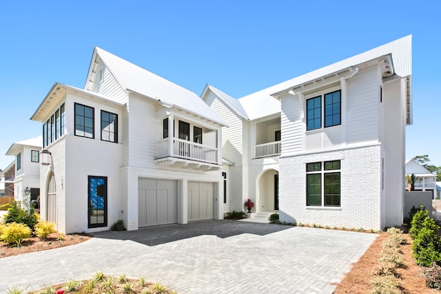 view of front of home with a garage and a balcony