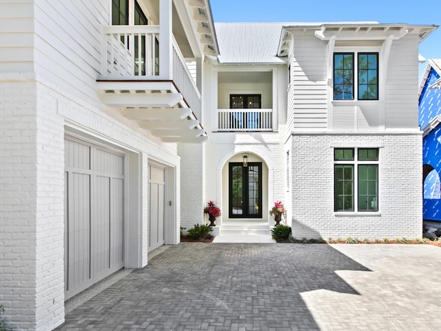 view of front of house featuring a garage and a balcony