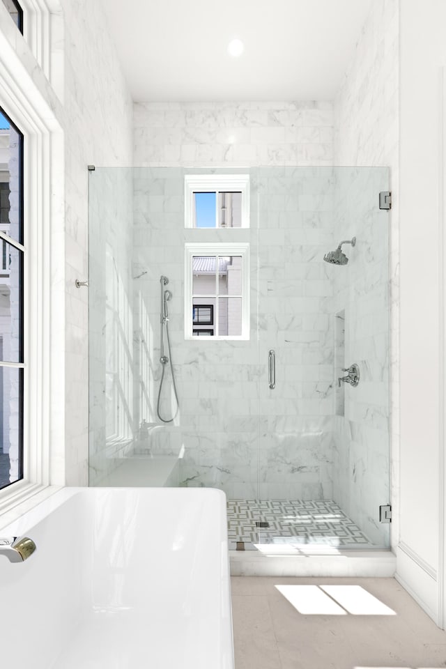 bathroom featuring a shower with shower door and tile flooring