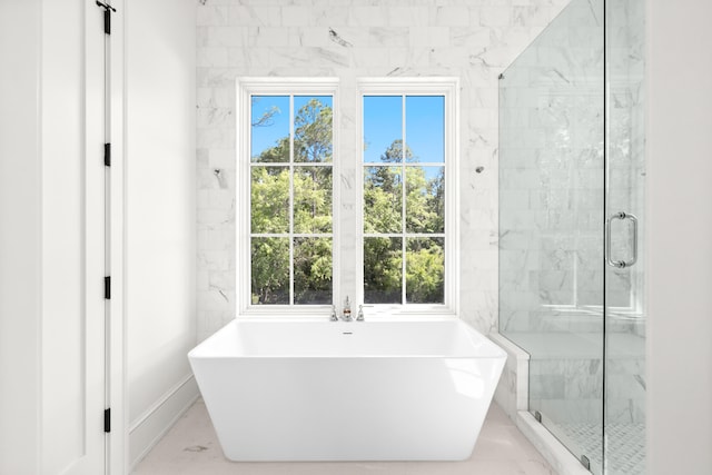 bathroom featuring tile walls, independent shower and bath, and tile flooring