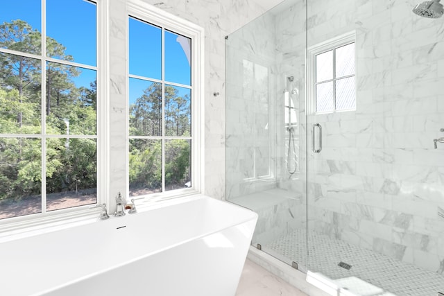 bathroom with plenty of natural light and plus walk in shower