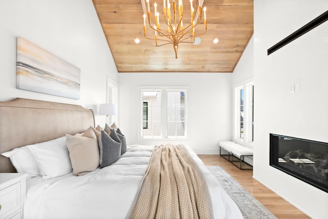 bedroom with wooden ceiling, vaulted ceiling, light hardwood / wood-style floors, and a chandelier