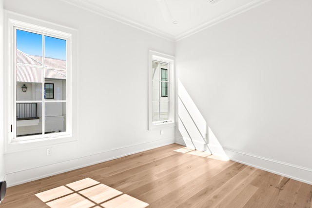 unfurnished room featuring crown molding and light wood-type flooring