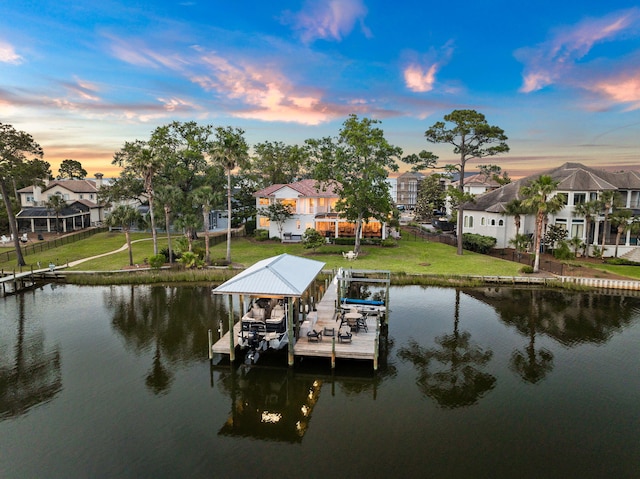 view of dock featuring a water view and a lawn