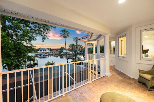 balcony at dusk with a water view