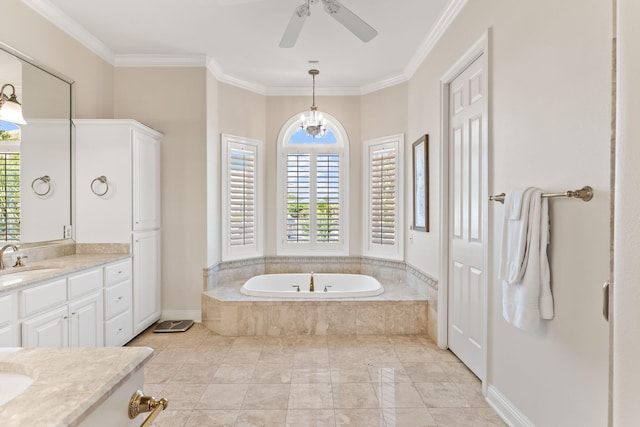 bathroom featuring a healthy amount of sunlight, vanity, and tiled bath