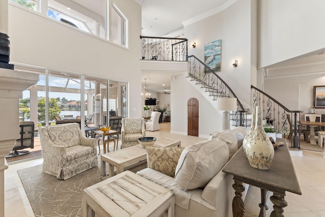 tiled living room with a high ceiling, crown molding, and plenty of natural light