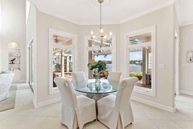 tiled dining space with ornamental molding, a healthy amount of sunlight, a chandelier, and built in shelves