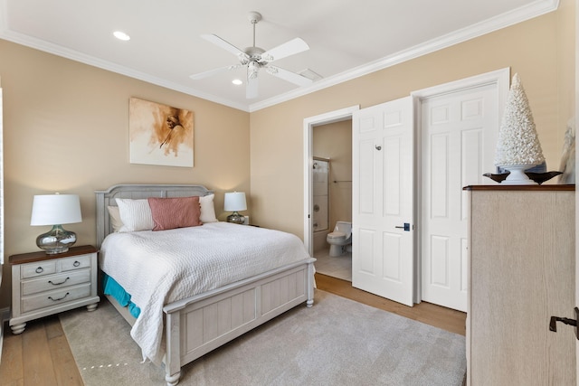 bedroom with ornamental molding, wood-type flooring, ceiling fan, and ensuite bathroom