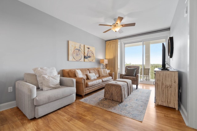 living room featuring wood-type flooring and ceiling fan