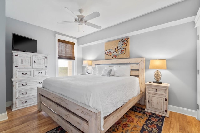 bedroom with light hardwood / wood-style flooring and ceiling fan