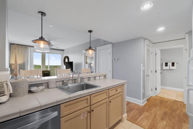 kitchen with ceiling fan, sink, dishwasher, hanging light fixtures, and light hardwood / wood-style flooring