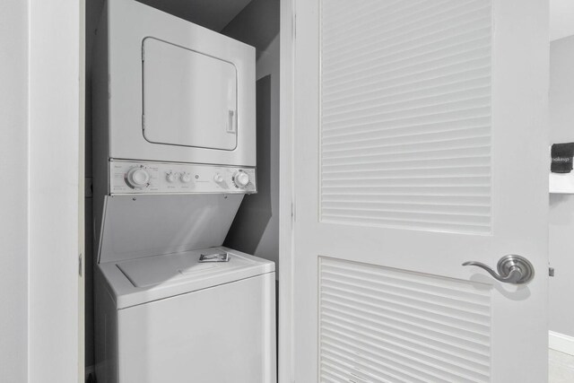 laundry area with stacked washer / dryer