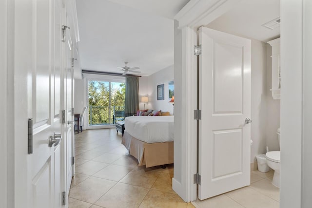 tiled bedroom with ceiling fan and ensuite bathroom