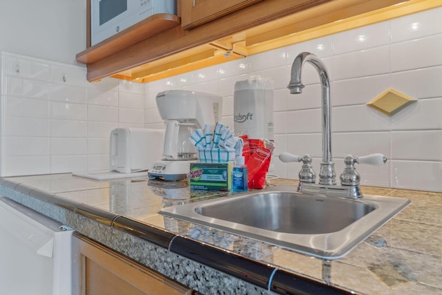 kitchen featuring tasteful backsplash and sink