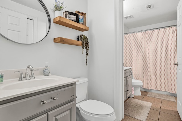 bathroom with tile patterned floors, vanity, and toilet