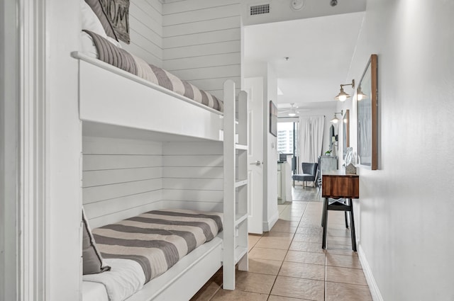 tiled bedroom with wooden walls