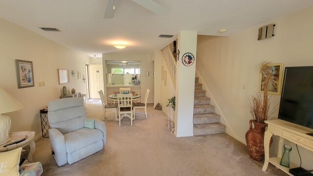 sitting room featuring ceiling fan and carpet flooring