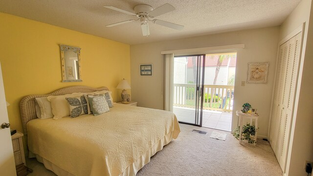 bedroom with a closet, ceiling fan, a textured ceiling, carpet flooring, and access to outside