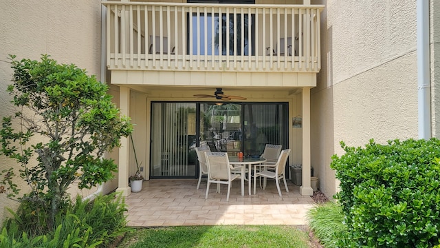 view of patio with a balcony and ceiling fan