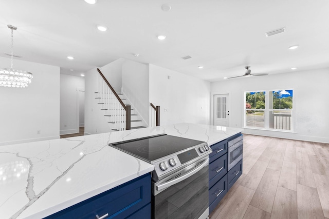 kitchen featuring stainless steel electric stove, ceiling fan with notable chandelier, light hardwood / wood-style floors, hanging light fixtures, and blue cabinets