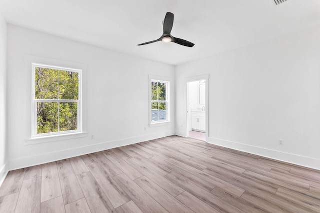 spare room with ceiling fan and light wood-type flooring