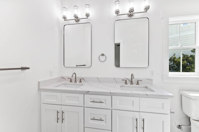 bathroom featuring toilet and vanity