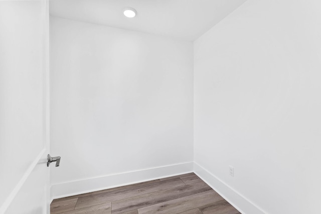 empty room with dark hardwood / wood-style flooring