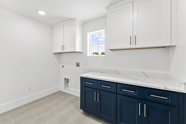 clothes washing area with washer hookup, electric dryer hookup, and cabinets