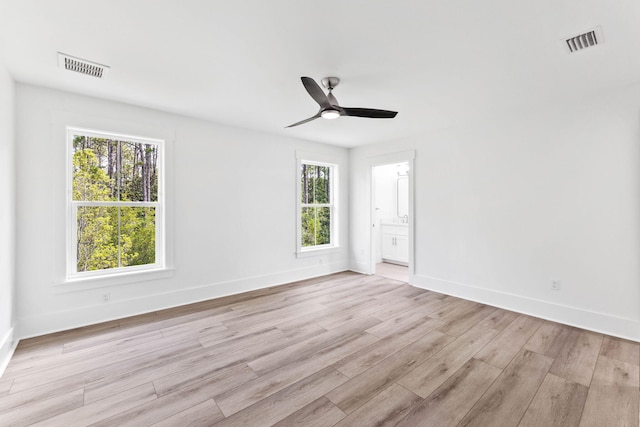 empty room featuring light wood-type flooring and ceiling fan