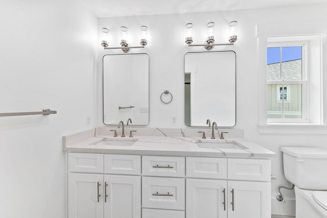 bathroom featuring toilet and vanity