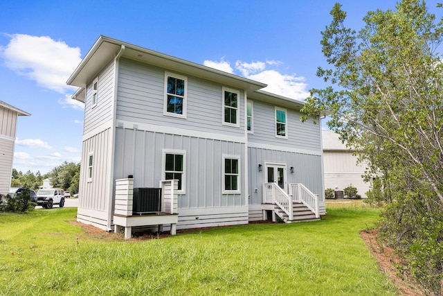 back of house with a lawn and cooling unit