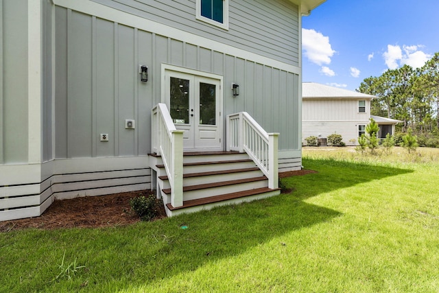 entrance to property with a lawn and french doors