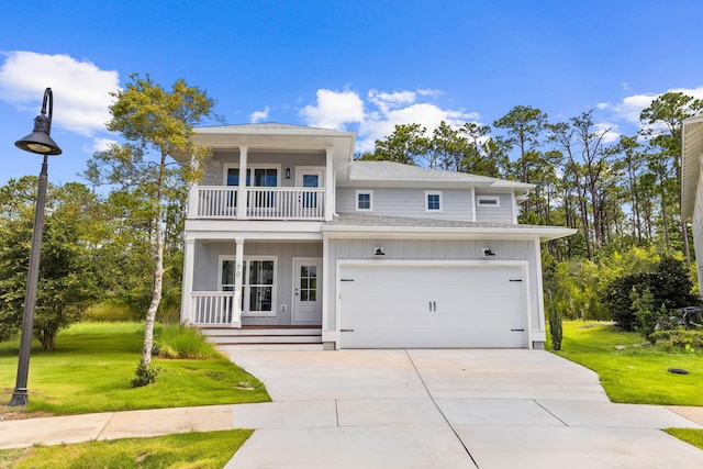 view of front facade featuring a garage, a front lawn, and a balcony