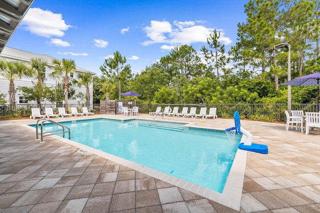 view of swimming pool with a patio