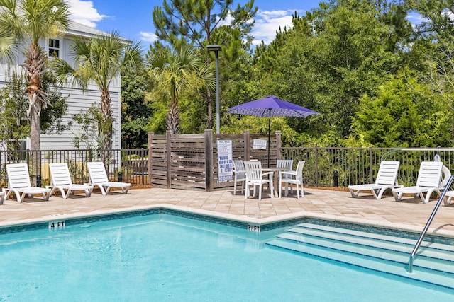 view of swimming pool featuring a patio area